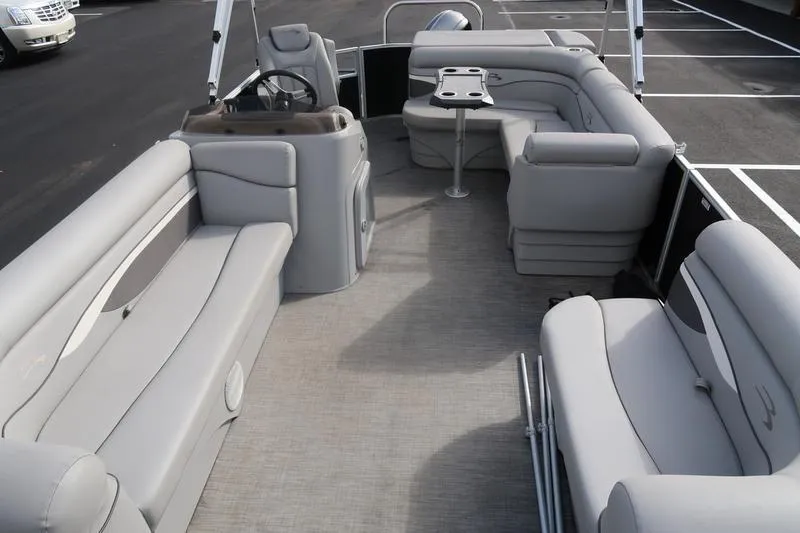 Slide: The Image of 2020 Bennington 20 SLMX pontoon boat interior with gray seating and steering console. - 7