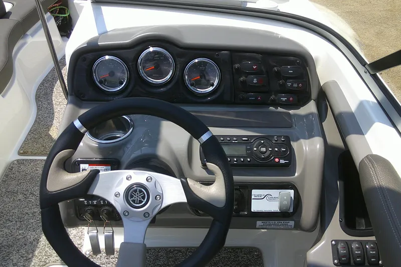 Slide: The Image of Dashboard of a 2010 Yamaha Boats 242 Limited S with steering wheel and controls. - 11