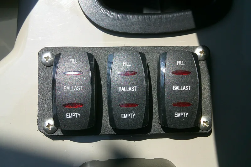 Slide: The Image of Ballast control switches on a 2010 Yamaha Boats 242 Limited S dashboard. - 12