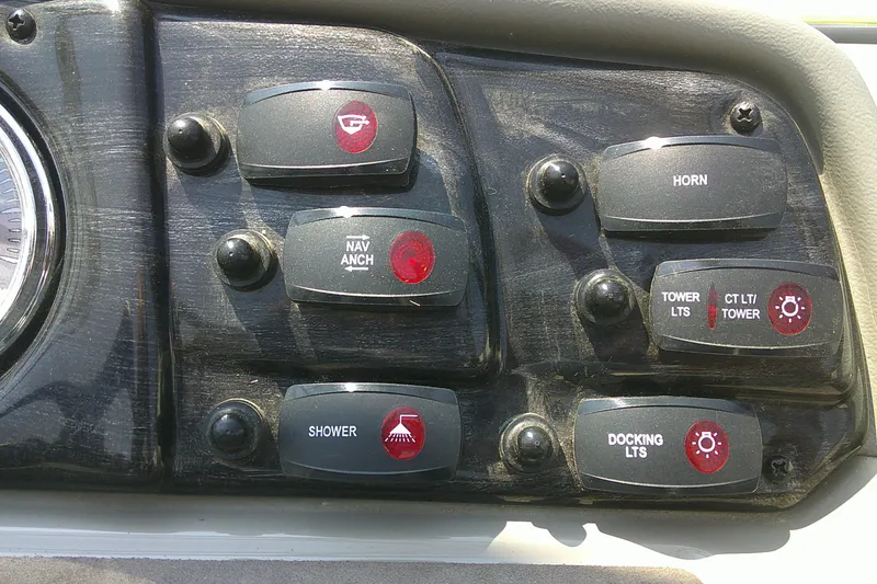 Slide: The Image of Control panel of a 2010 Yamaha Boats 242 Limited S with various switches. - 14