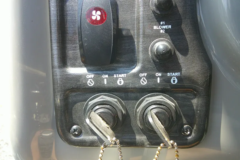 Slide: The Image of Control panel of a 2010 Yamaha Boats 242 Limited S with ignition keys and blower switch. - 15