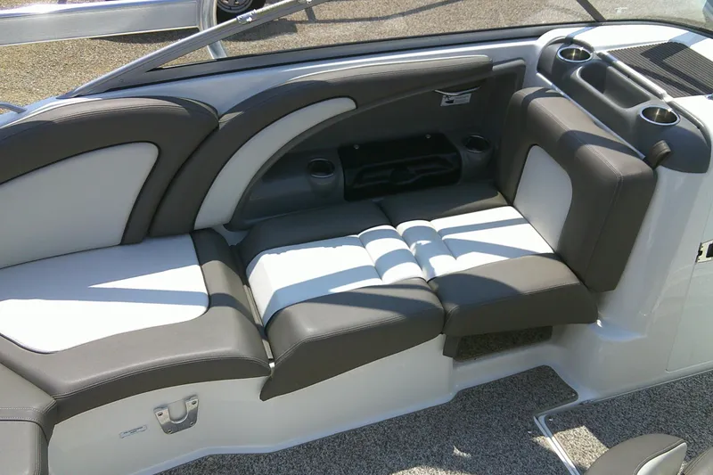 Slide: The Image of 2010 Yamaha Boats 242 Limited S interior seating with cup holders and sleek design. - 18