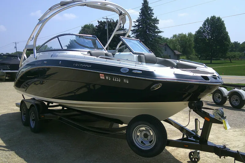 Slide: The Image of 2010 Yamaha Boats 242 Limited S on trailer, parked outdoors. - 2