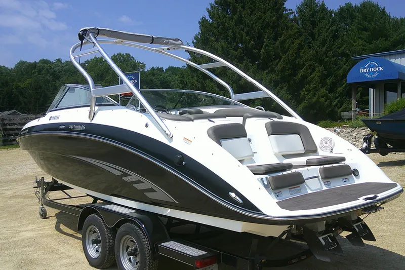Slide: The Image of 2010 Yamaha Boats 242 Limited S on trailer, sleek design, outdoor setting. - 26