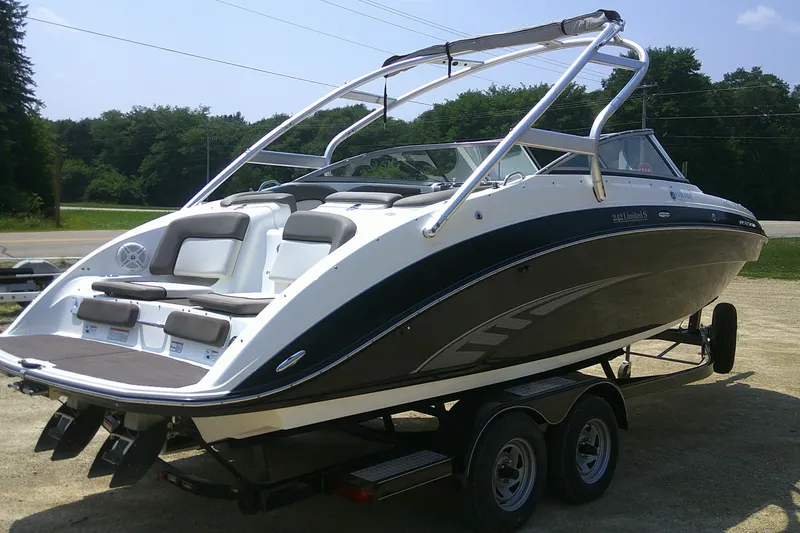 Slide: The Image of 2010 Yamaha Boats 242 Limited S on trailer, sleek design, outdoor setting. - 27