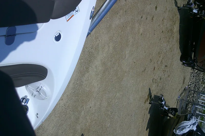 Slide: The Image of 2010 Yamaha Boats 242 Limited S on sandy ground, partial view of boat interior. - 8