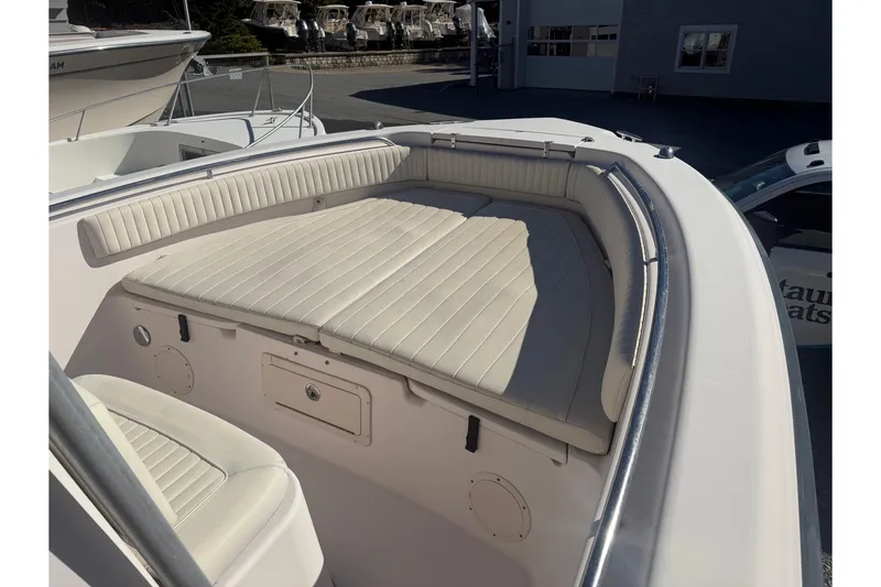 Slide: The Image of 2005 Grady-White Advance 257 boat on display, elevated on blocks, with a blue canopy. - 1