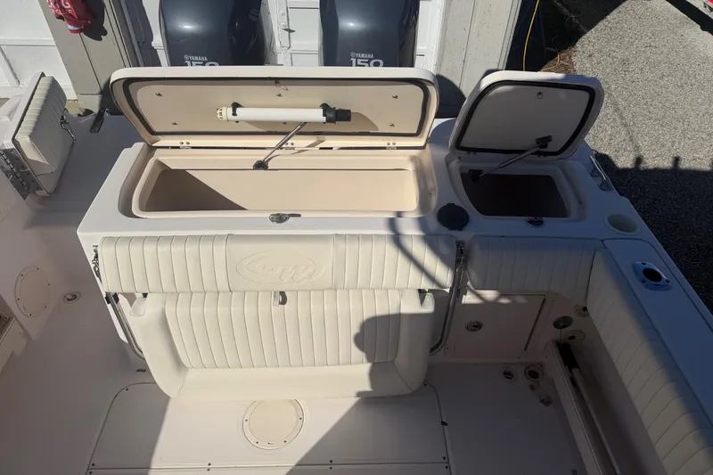 Slide: The Image of 2005 Grady-White Advance 257 boat interior with Yamaha 150 engines, featuring seating and storage. - 10