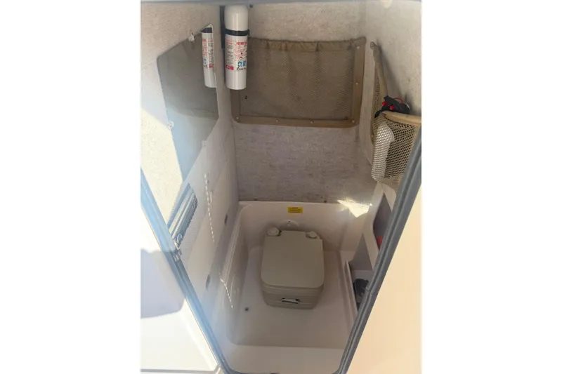 Slide: The Image of 2005 Grady-White Advance 257 boat interior with open storage compartments and Yamaha engines. - 11