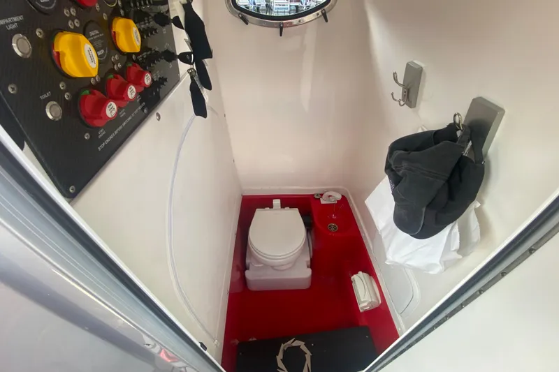 Slide: The Image of 2021 Fountain 34 SC boat interior with toilet and control panel. - 16