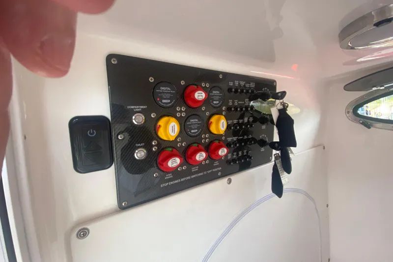 Slide: The Image of Control panel of 2021 Fountain 34 SC boat with switches and keys. - 17