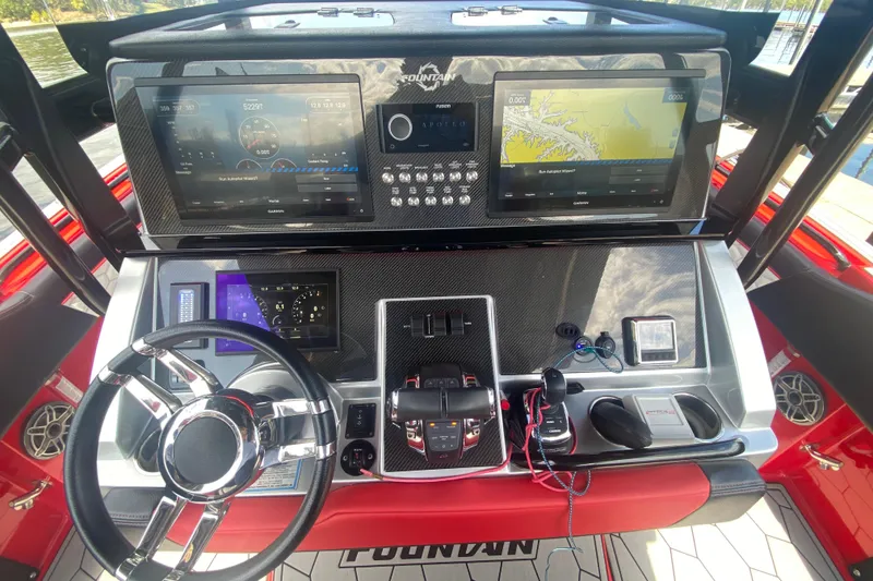 Slide: The Image of 2021 Fountain 34 SC boat dashboard with advanced navigation and control systems. - 20