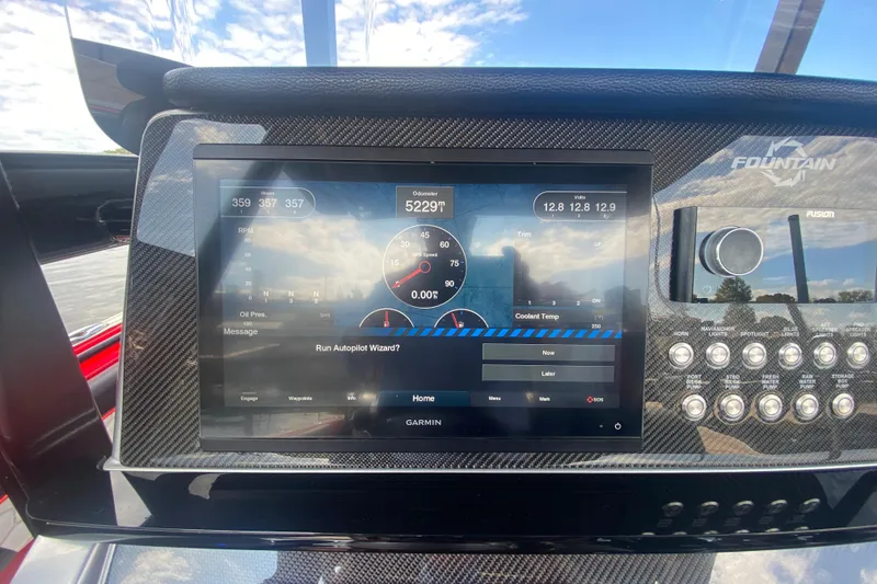 Slide: The Image of 2021 Fountain 34 SC dashboard with Garmin display and control panel. - 24
