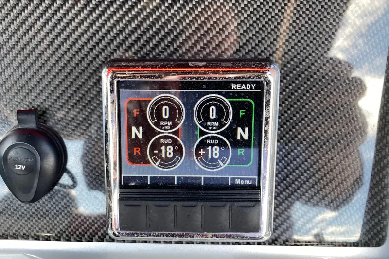 Slide: The Image of Digital control panel on 2021 Fountain 34 SC boat dashboard with carbon fiber finish. - 28