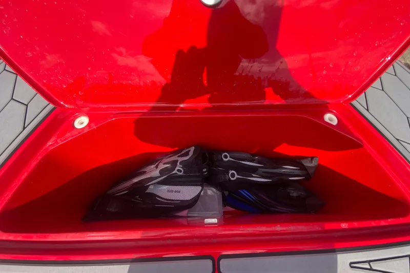 Slide: The Image of Open red storage compartment on 2021 Fountain 34 SC boat with diving gear inside. - 37