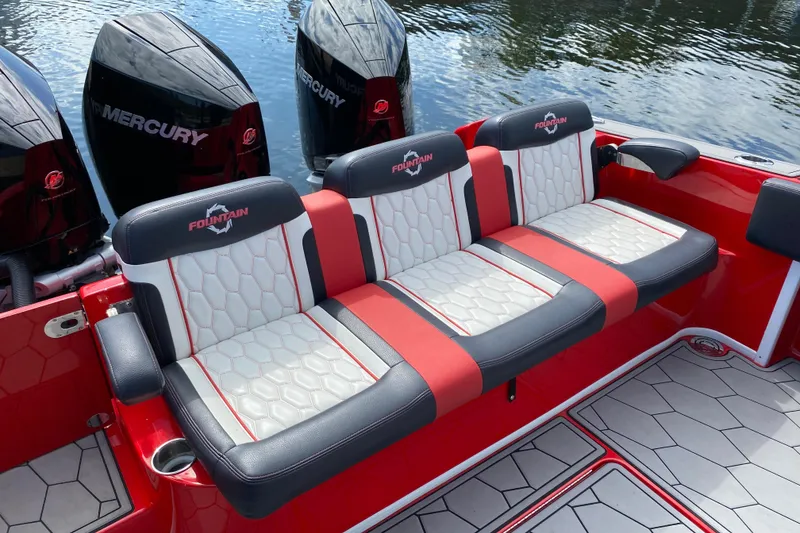 Slide: The Image of 2021 Fountain 34 SC boat with red and white seating, Mercury engines, on water. - 45
