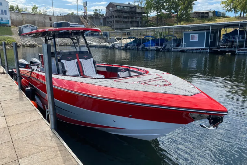 Slide: The Image of Red 2021 Fountain 34 SC boat docked at a marina, showcasing sleek design and modern features. - 46
