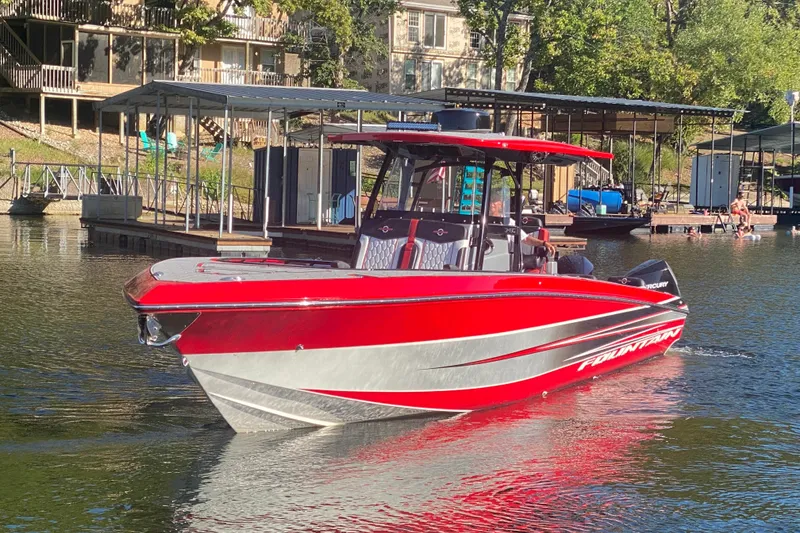 Slide: The Image of Red 2021 Fountain 34 SC boat docked on a sunny lake. - 5
