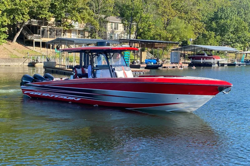 Slide: The Image of 2021 Fountain 34 SC boat in vibrant red on a serene lake. - 6