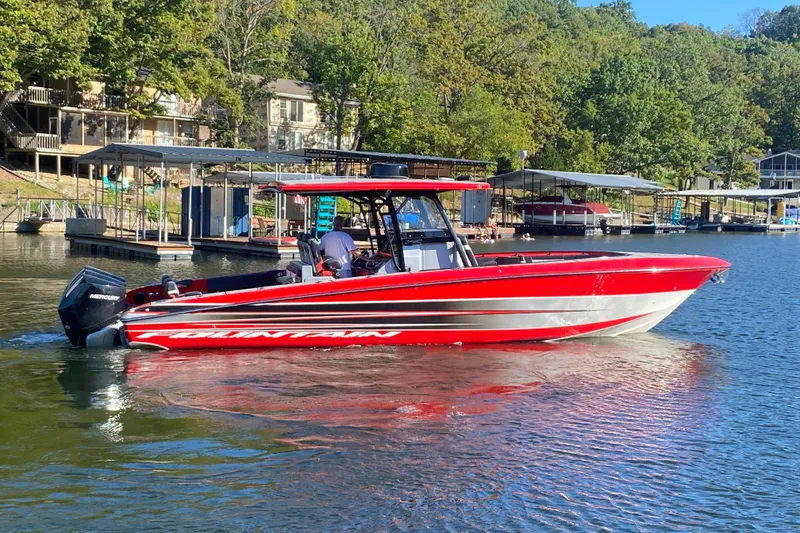 Slide: The Image of 2021 Fountain 34 SC boat in vibrant red on a serene lake. - 7