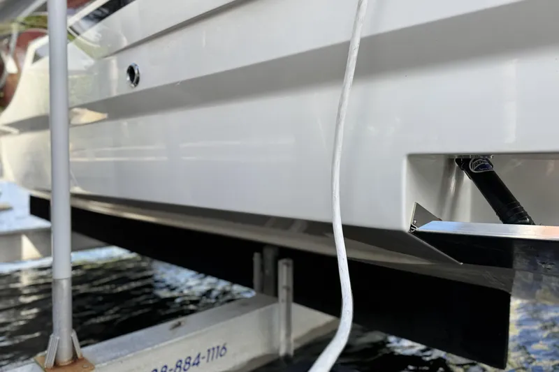 Slide: The Image of 2021 Formula 330 Crossover Bowrider OB on a lift, close-up view of hull details. - 11