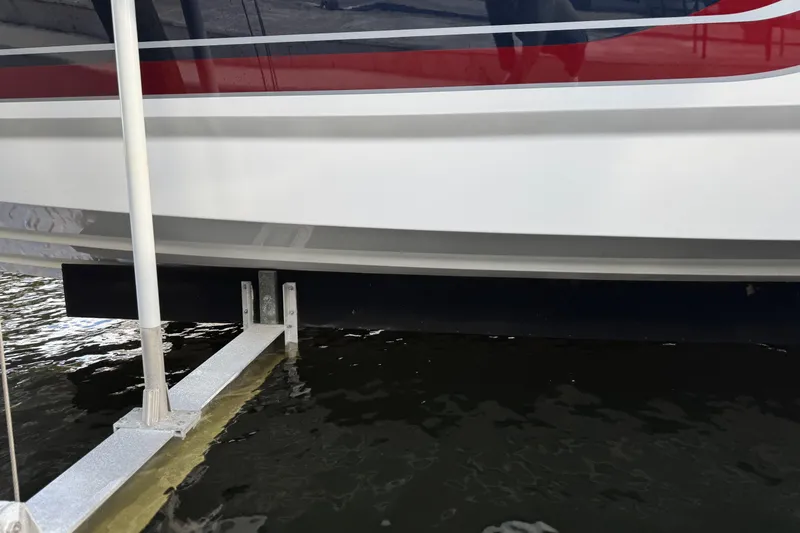 Slide: The Image of 2021 Formula 330 Crossover Bowrider OB hull above water at dock. - 12