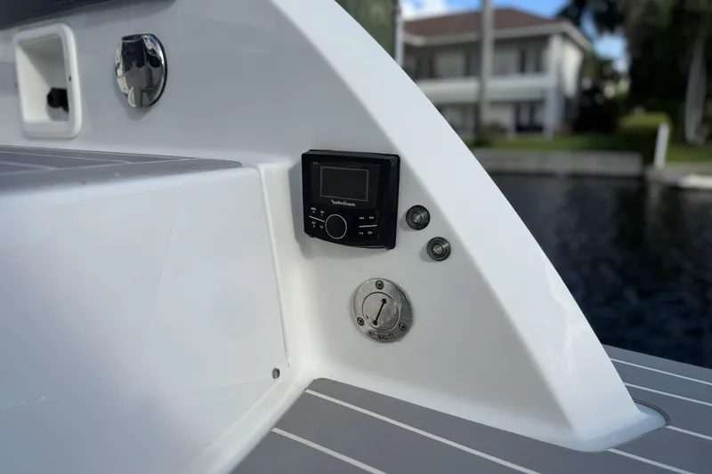 Slide: The Image of 2021 Formula 330 Crossover Bowrider OB boat control panel and waste outlet. - 15