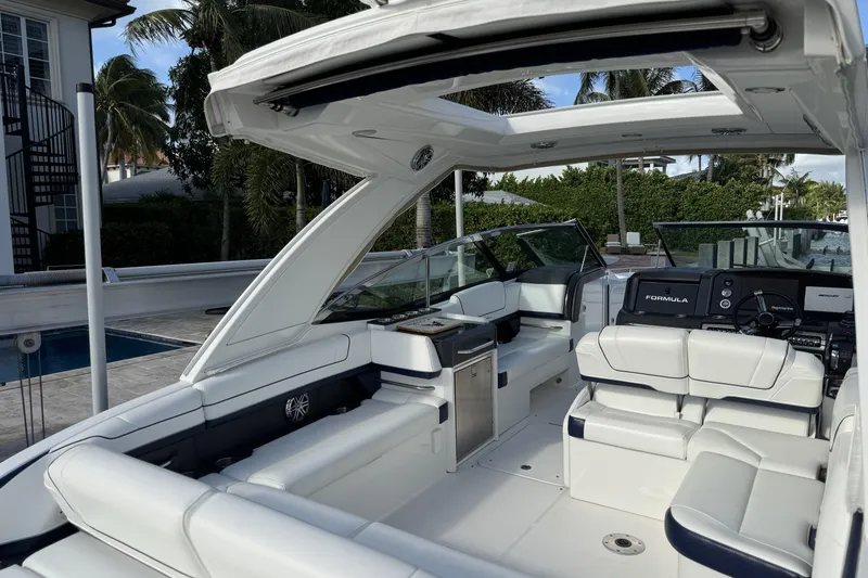 Slide: The Image of 2021 Formula 330 Crossover Bowrider OB with luxurious seating and modern dashboard. - 19