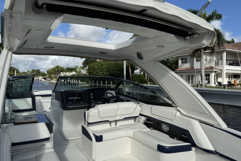 Slide: The Image of 2021 Formula 330 Crossover Bowrider OB interior with luxurious seating and open roof design. - 20
