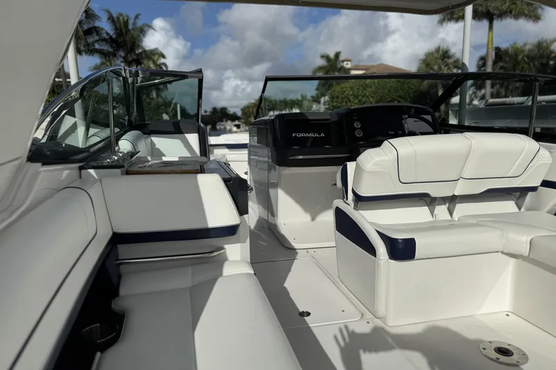 Slide: The Image of 2021 Formula 330 Crossover Bowrider OB interior with white seating and modern dashboard. - 21