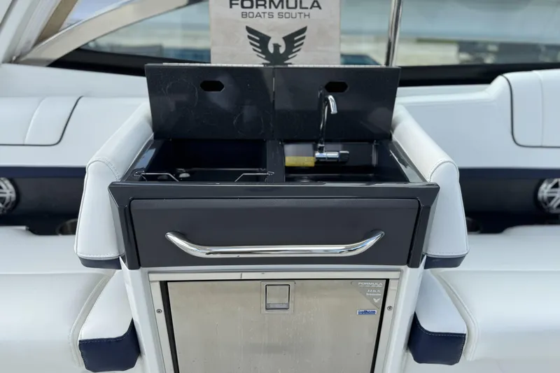 Slide: The Image of 2021 Formula 330 Crossover Bowrider OB boat interior with sink and storage. - 27