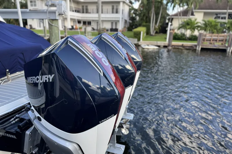 Slide: The Image of 2021 Formula 330 Crossover Bowrider OB with Mercury outboard engines by the water. - 3