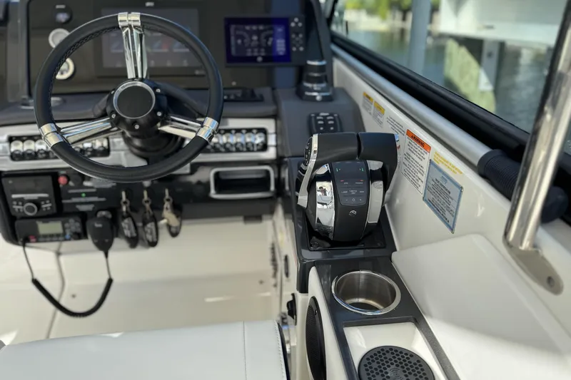 Slide: The Image of 2021 Formula 330 Crossover Bowrider OB helm with steering wheel and controls. - 32