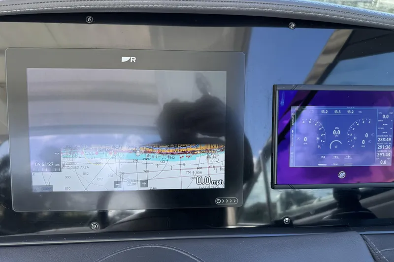 Slide: The Image of Dashboard of 2021 Formula 330 Crossover Bowrider OB with navigation and control screens. - 35