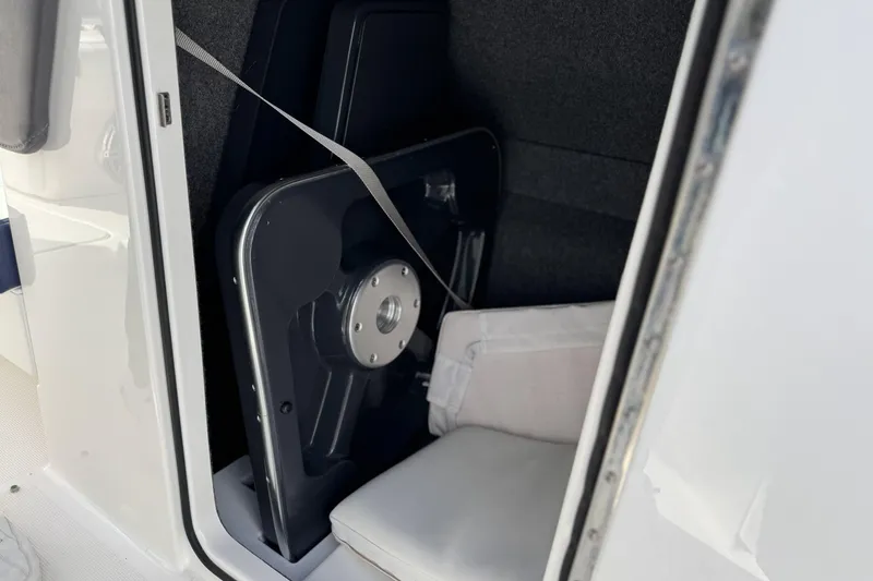 Slide: The Image of 2021 Formula 330 Crossover Bowrider OB interior storage compartment with secured equipment. - 39