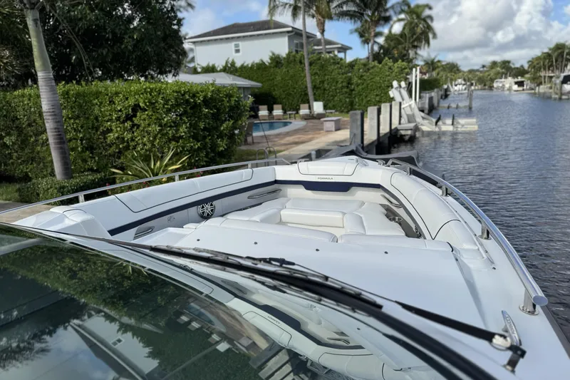 Slide: The Image of 2021 Formula 330 Crossover Bowrider OB docked by a lush canal. - 42