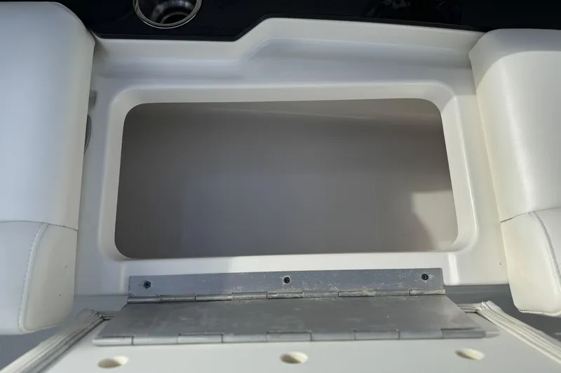 Slide: The Image of 2021 Formula 330 Crossover Bowrider OB storage compartment with white cushioned seating. - 43