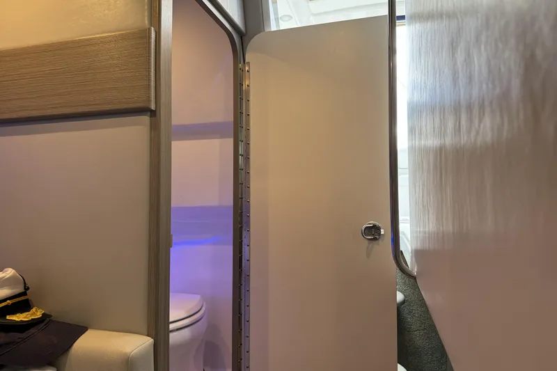 Slide: The Image of Interior view of 2021 Formula 330 Crossover Bowrider OB, featuring a compact bathroom. - 56