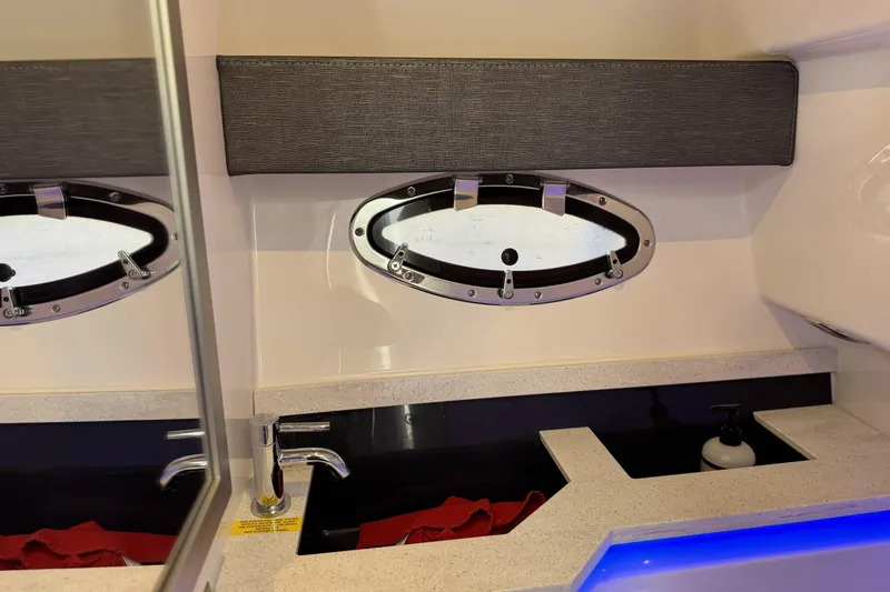Slide: The Image of 2021 Formula 330 Crossover Bowrider OB interior with sink and porthole window. - 58