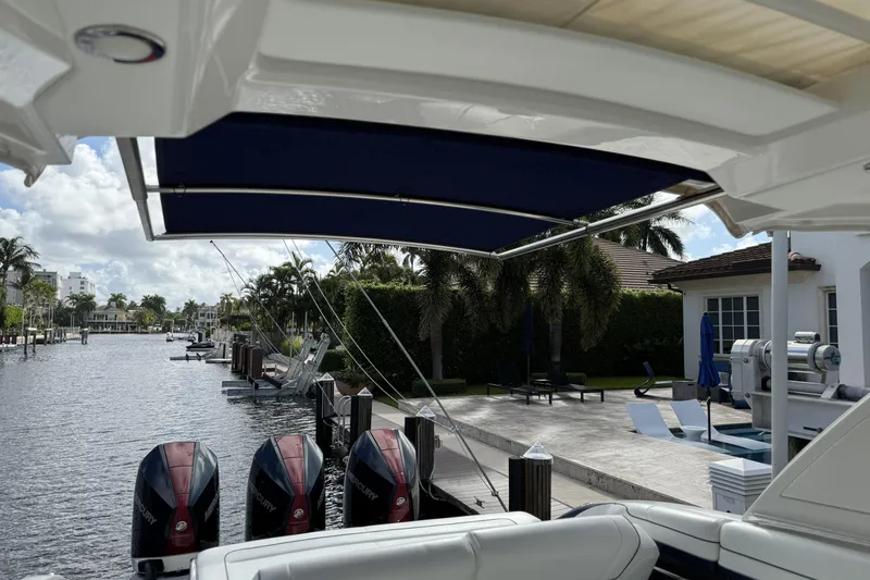 Slide: The Image of 2021 Formula 330 Crossover Bowrider OB docked by a luxurious waterfront property. - 60
