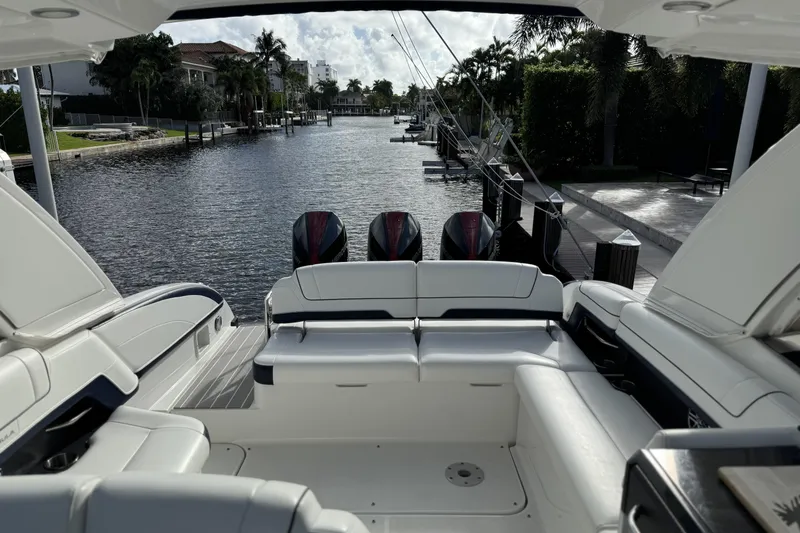Slide: The Image of 2021 Formula 330 Crossover Bowrider OB, luxurious interior, docked by a scenic canal. - 61