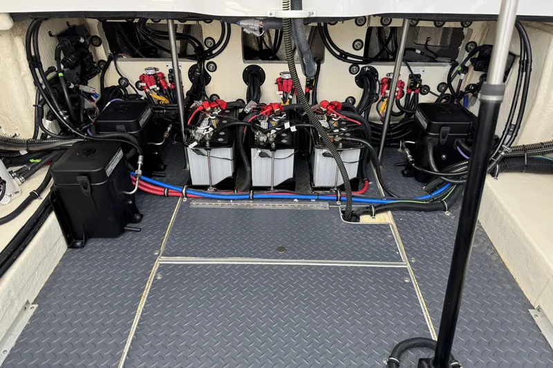 Slide: The Image of Engine compartment of 2021 Formula 330 Crossover Bowrider OB with batteries and wiring. - 64