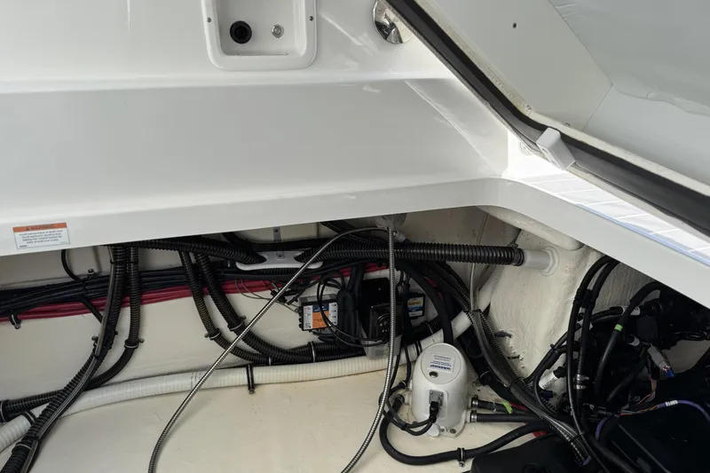 Slide: The Image of 2021 Formula 330 Crossover Bowrider OB engine compartment with wiring and components. - 66