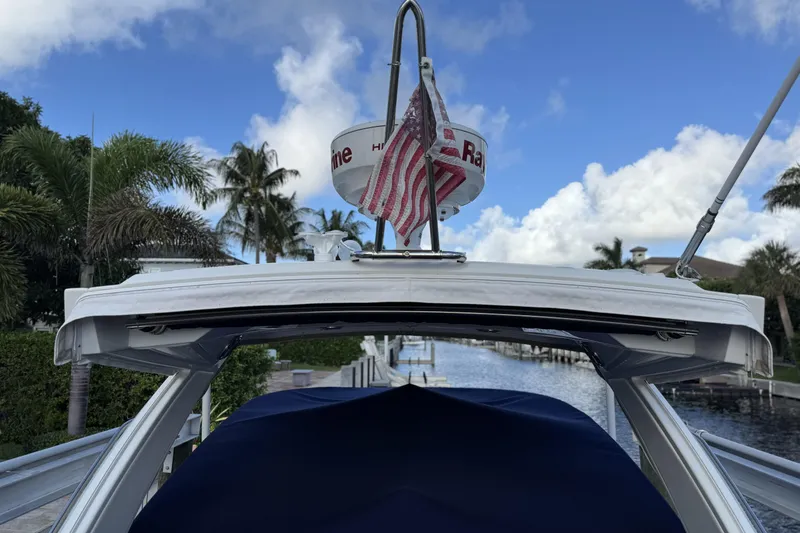 Slide: The Image of 2021 Formula 330 Crossover Bowrider OB docked, featuring radar and American flag. - 7