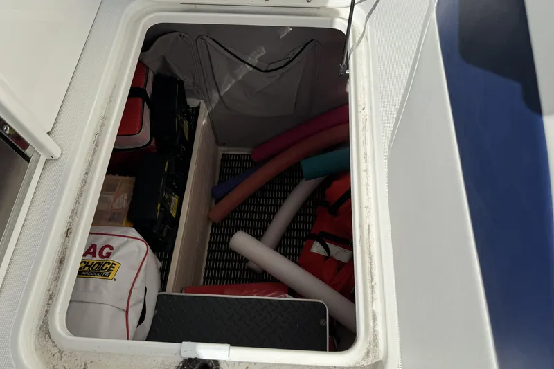 Slide: The Image of Storage compartment of 2021 Formula 330 Crossover Bowrider OB with boating accessories. - 70