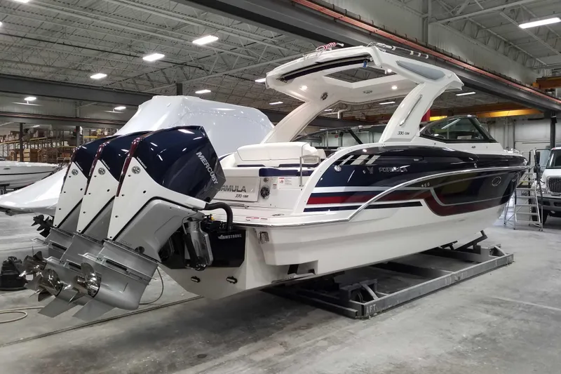 Slide: The Image of 2021 Formula 330 Crossover Bowrider OB in a warehouse, featuring dual outboard engines. - 71