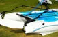 Slide: The Image of 2002 Hobie Cat Hobie Club Wave catamaran on grass, featuring blue and white design. - 7