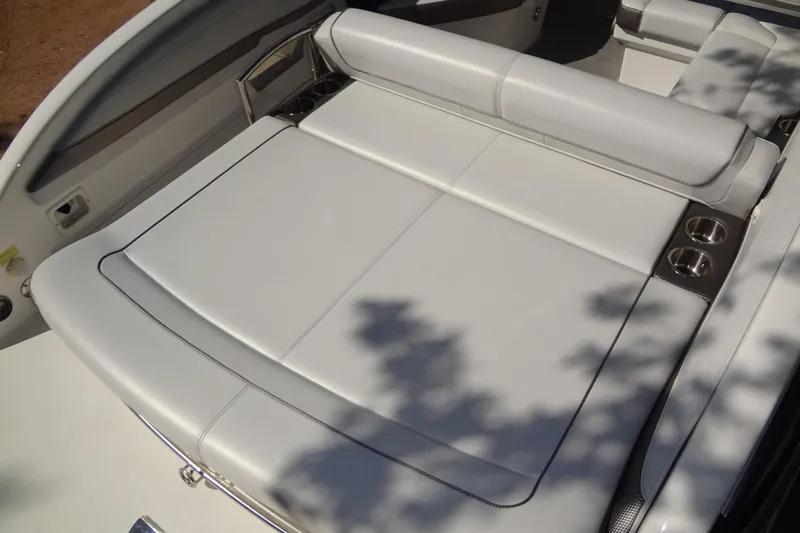 Slide: The Image of 2020 Formula 240 Bowrider boat on trailer, parked outdoors under clear sky. - 14