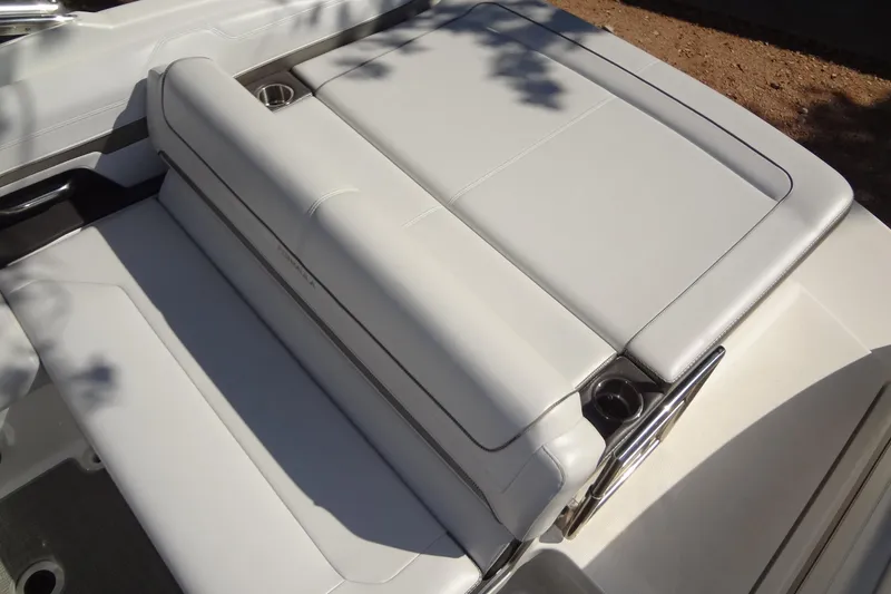 Slide: The Image of 2020 Formula 240 Bowrider boat on trailer, parked outdoors under trees. - 15