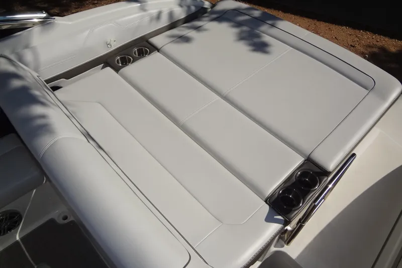 Slide: The Image of 2020 Formula 240 Bowrider boat on trailer, parked outdoors under trees. - 16